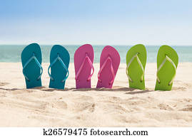 Pairs Of Flip-flops On Beach
