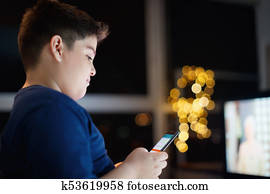 Unattended Boy Chatting And Typing On Mobile Phone At Night