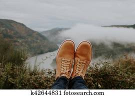 boots in the foreground on the panoramic view of the Valley, concept of adventure and travel