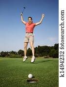 Happy woman golfing.