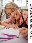 Woman painting in drawing book Woman painting in drawing book