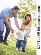Family running outdoors smiling Family running outdoors smiling