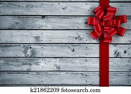 Composite image of red christmas bow and ribbon