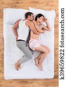 Lovely couple sleeping on bed