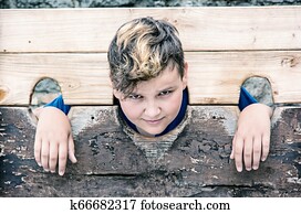 Young caucasian boy in medieval pillory
