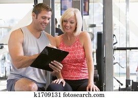 Personal Trainer Talking To Woman At Gym Personal Trainer Talking To Woman At Gym