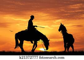 Rodeo cowboy at sunset Rodeo cowboy at sunset