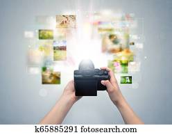 Hand captures life events with digital camera