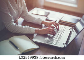 Businesswoman typing on laptop at workplace Woman working in home office hand keyboard.