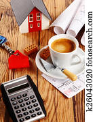 Coffee, House, Blueprint and Calculator on a Table