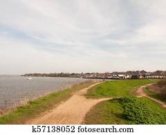 long walkway trail at side of bay of water uk manningtree nature background