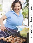 Woman Cooking On A Barbeque Woman Cooking On A Barbeque