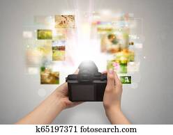 Hand captures life events with digital camera