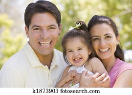 Family standing outdoors smiling