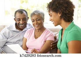 Senior Couple Talking To Financial Advisor At Home Senior Couple Talking To Financial Advisor At Home