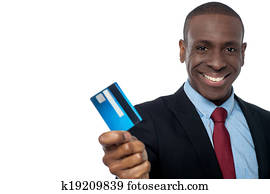 Cheerful businessman holding credit card