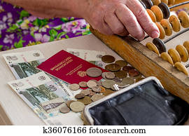 Elderly caucasian woman counting money