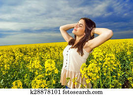 Young woman standing rapeseed