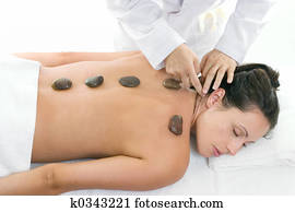 Female receiving a relaxing massage treatment Female receiving a relaxing massage treatment