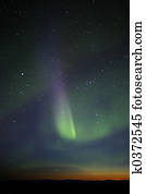 Green-purple streak of aurora over twilight horizon. Many stars visible. The end phase of display, however still powerful and colorful enough.