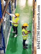 Asian and African warehouse workers team do inventory, Top view.