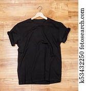 Black shortsleeve cotton tshirt on a wooden backgronud