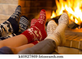 Family in socks near fireplace in winter or christmas time Family in socks near fireplace in winter or christmas time