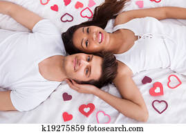 Young Couple Lying On Mattress