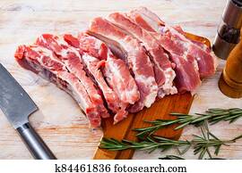 Raw pork ribs on wooden table Raw pork ribs on wooden table