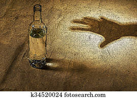 the hand reaching for bottle of alcohol the hand reaching for bottle of alcohol