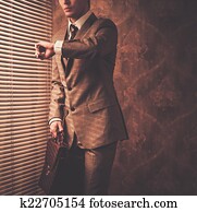 Well-dressed businessman looking at his watch