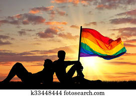 Silhouette of two gay vacationers at sunset