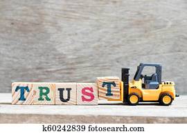 speelbal, vorkheftruck, houden, brief, blok, t, om te, compleet, woord, vertrouwen, op, hout, achtergrond