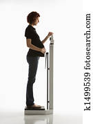 Pregnant woman checking weight.