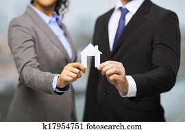 businessman and businesswoman holding white house