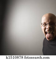 Man sticking out tongue.