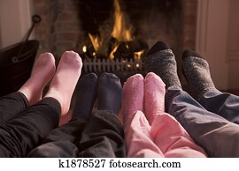 Family of Feet warming at a fireplace Family of Feet warming at a fireplace