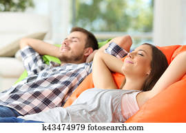 Couple or roommates relaxing at home