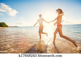 Happy Couple on Tropical Beach at Sunset