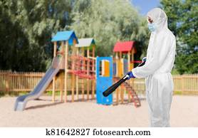 sanitation worker in hazmat with pressure washer sanitation worker in hazmat with pressure washer