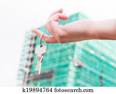 A real estate agent holding keys to a new apartment in her hands.