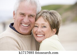 Couple at the beach smiling