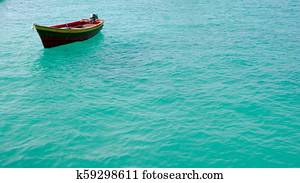 fishing boat on a shimmering ocean