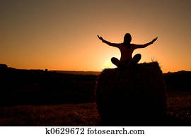 Woman silhouette making yoga