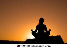 Woman silhouette making yoga