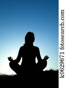 Woman silhouette making yoga