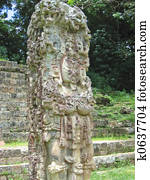 Maya deus stone statue with some coloured paint - Copan - Honduras.