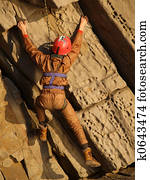 climber on the yellow red volcanic rock