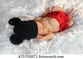 newborn baby in mouse costume sleeping on fur bed newborn baby in mouse costume sleeping on fur bed