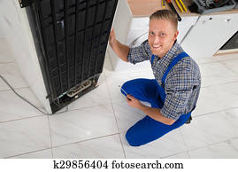 Repairman Repairing Fridge